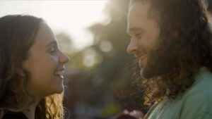 Photo of young woman and man smiling at each other lovingly